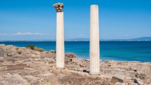 White pillars with a blue sea in the background