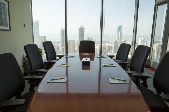 Anthropology focus groups. Image of a long brown table with black chairs around it and a large window overlooking the city.